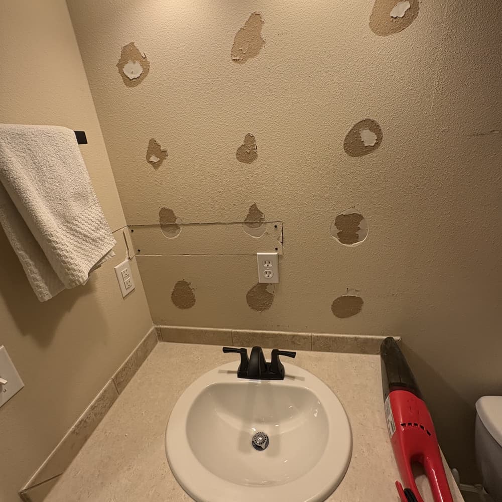 The same vanity wall before painting, covered in drywall patch compound