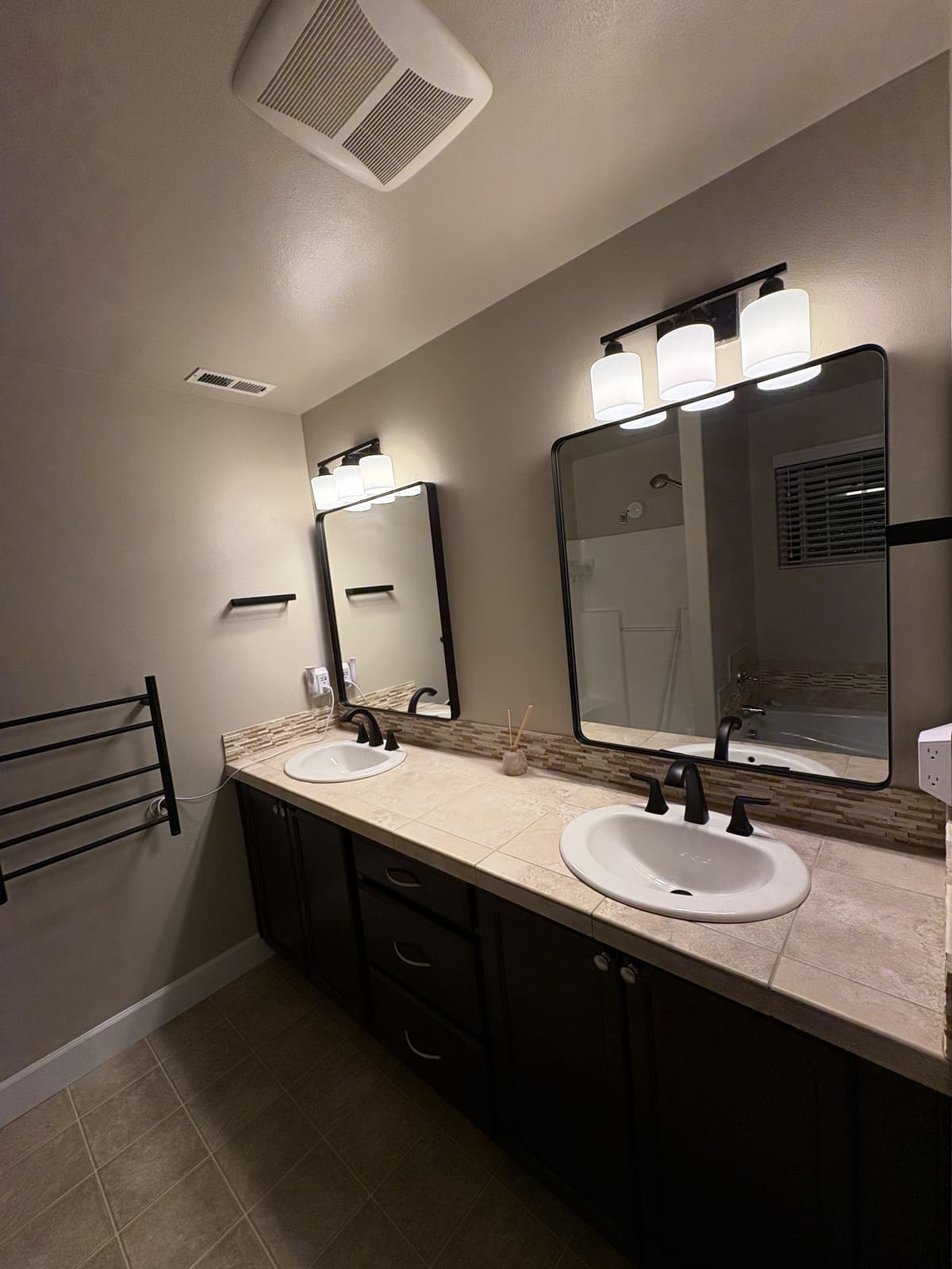 Double vanity with new framed mirrors and vanity lighting
