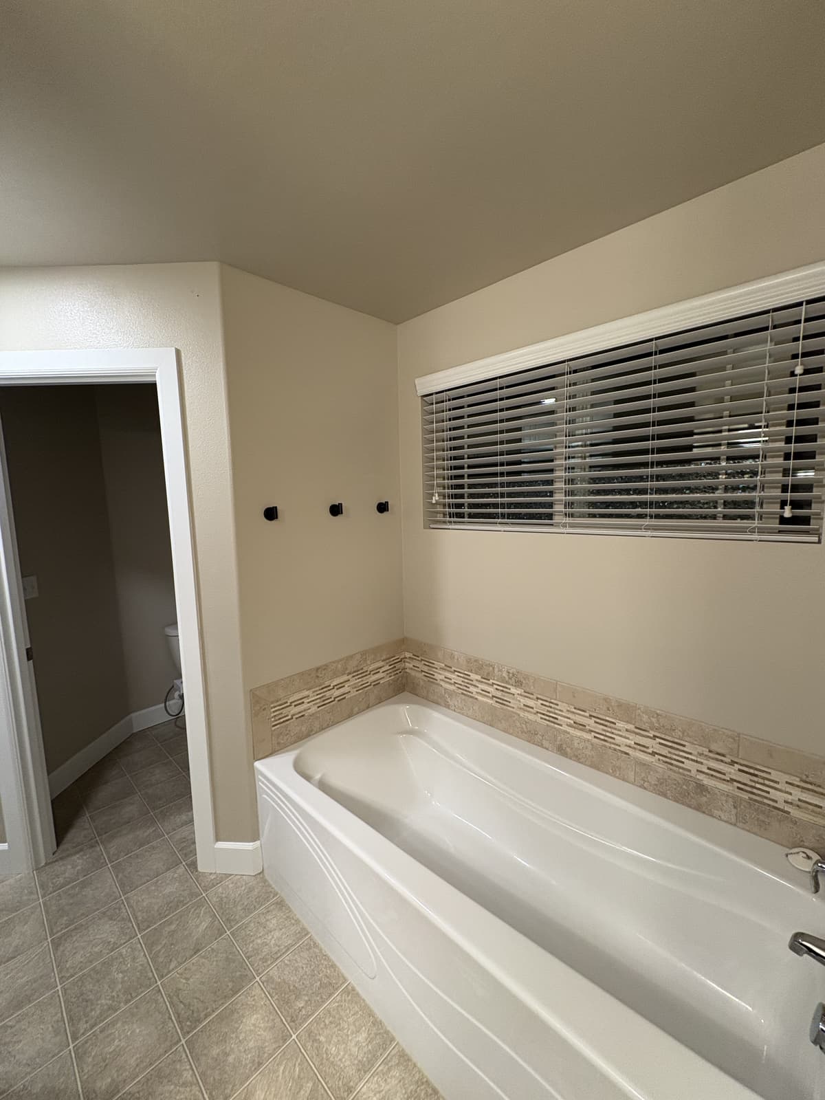 Soaking tub with tile surround and repainted walls