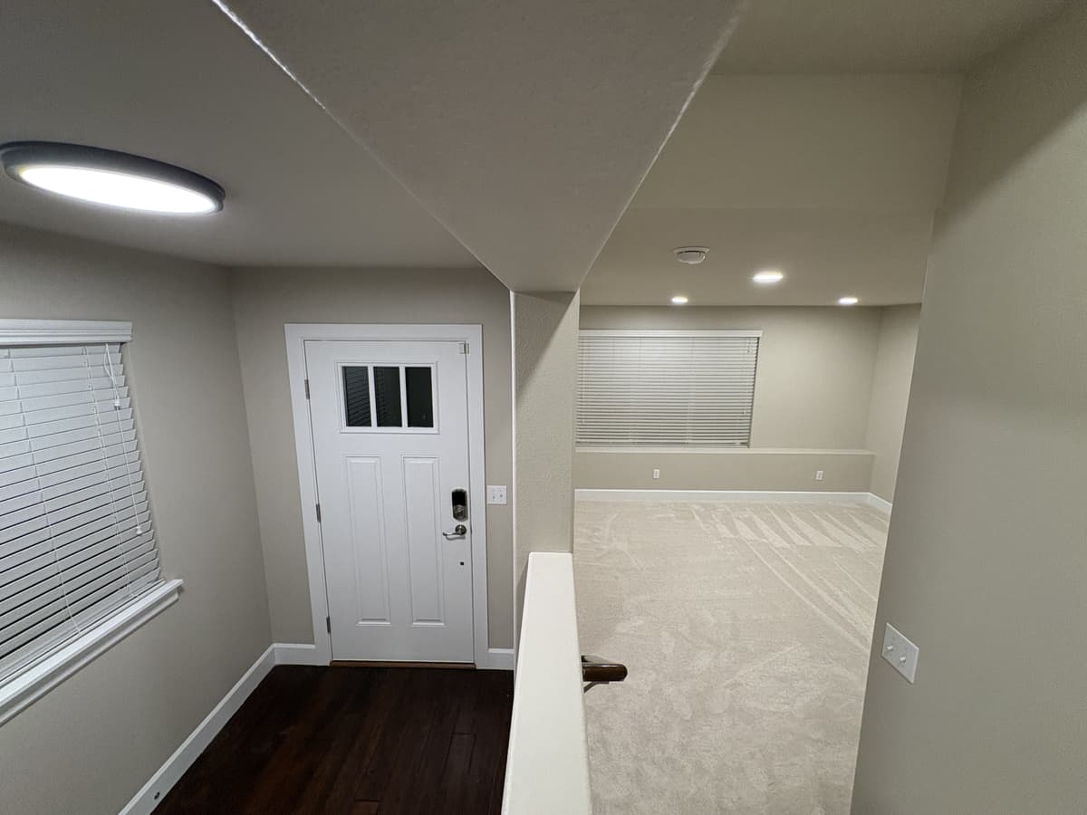 Entry and foyer with repainted walls and new carpet beyond